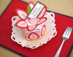 a red place mat with a small cake on it