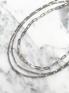 This statement necklace consists of three rows: A top open link chain and two rows of flat panel chain for a trendy layered style. Choose from silver or gold plated. Adjustable length 16'19" long. Wear on its own or stack up with more necklaces here! Layer Chain Necklace, Layer Chain, Layered Style, Layered Chain Necklace, Layered Chains, Silver Chain Necklace, Link Chain, The Row, Silver Plate