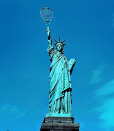 the statue of liberty is holding a tennis racket