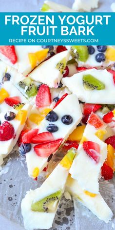 frozen yogurt fruit bark on a plate with berries and kiwis in it