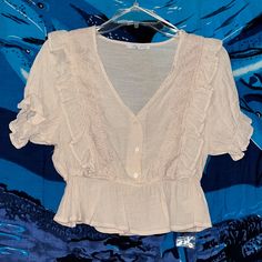 Nwot Love Tree Blouse. Cropped. Lightweight Material. V-Neck, Cinched Sleeves, Beautiful Details. Cream Color. Comes With An Extra Button. Size Medium. Never Worn. Perfect Condition! Feminine V-neck Top For Day Out, Spring V-neck Lace Top Blouse, Feminine Button-up Tops For Vacation, Spring V-neck Tops With Lace Trim, Summer V-neck Blouse With Ruffles, Casual Lace Top With V-neck, Lace Top V-neck Blouse, V-neck Blouse With Lace Trim For Daywear, Feminine Cotton V-neck Blouse