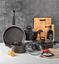 an assortment of pots and pans on a table