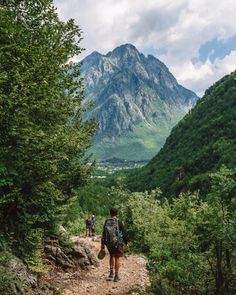 people hiking up a trail in the mountains