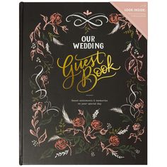 the wedding guest book with gold lettering and roses on black paper, is shown in front of a white background