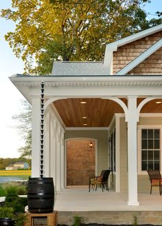 a small house with a porch and covered patio