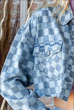 Denim jackets are a fashion staple. This denim shirt jacket features two denim colors woven into a unique checkered pattern. The crop styling features a four button front, button flap pockets and button cuffs. It has a back straight yolk accented with off-center pleats. The double top stitched collar has rounded points and the jacket has an unfinished hem. This is the perfect topper for sun dresses and anytime you need a medium-weight layer. Woven Two-Tone Denim Checkered Pattern Button Front, P Trendy Light Wash Button-up Shacket, Plaid Denim Outerwear With Pockets, Trendy Button-up Denim Jacket With Patch Pockets, Trendy Button-up Shacket With Patch Pockets, Trendy Denim Shacket With Snap Buttons, Spring Plaid Denim Outerwear, Trendy Medium Wash Shacket With Buttoned Pockets, Plaid Shacket With Pockets For Spring, Spring Plaid Shacket With Button Closure