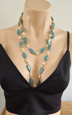 A pretty necklace of very light faux turquoise and pearl beads with gold tone wire spacing. The necklace is very versatile and can be worn as a single strand, wound around the neck or indeed as a two string necklace. The necklace measures 120 cm/47 inches Condition Being a vintage piece, any notable damage, missing parts or wear will be described as accurately as possible. However, minor imperfections & signs of wear should be expected. Please consider pictures provided as part of the descriptio String Necklace, Pretty Necklace, Long Lights, Long Light, Necklace Beads, Flapper Style, Pretty Necklaces, Light Turquoise, Beaded Necklaces