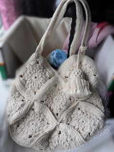 a white crocheted purse sitting on top of a table