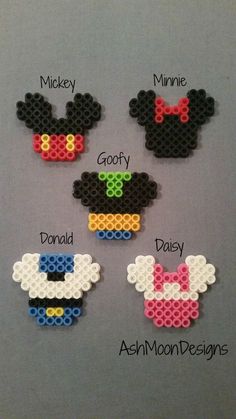 some mickey mouses are made out of perler beads and have different designs on them