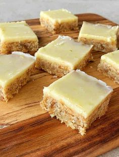 pieces of cake sitting on top of a wooden cutting board