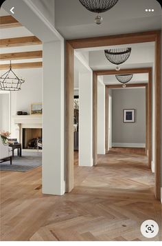 an empty hallway with wood floors and white walls