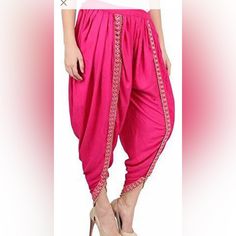 Rayon Fabric Dhoti Pants With Foil Mirror Lace. Elastic Waist Adjustable Till Size 42. Length 37”. Color Options Are Fuchia Pink Traditional Drape Summer Festive Pants, Summer Festive Pants With Traditional Drape, Festive Summer Pants With Traditional Drape, Traditional Pink Pants For Festive Occasions, Bollywood Style Festive Bottoms With Traditional Drape, Pink Fitted Traditional Pants, Bollywood Style Festive Bottoms For Spring, Bollywood Style Festive Bottoms For Navratri, Festive Fitted Bottoms With Traditional Drape