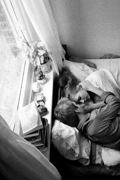 a man and woman sleeping in bed next to each other