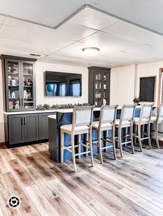 an empty kitchen with blue and white chairs