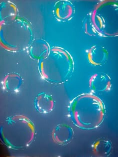 soap bubbles floating in the air on a blue background