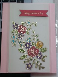 a card with flowers on it sitting next to a keyboard