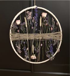 a wicker circle with flowers hanging from it