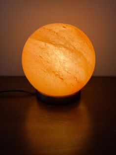 an orange light sitting on top of a wooden table