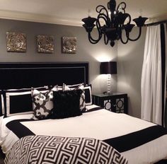 a black and white bedroom with a chandelier