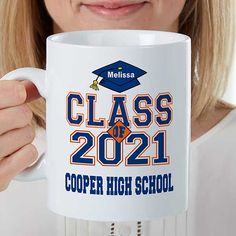 a woman is holding a coffee mug with her name and graduation cap on the front