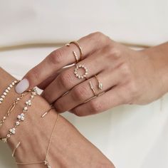 a woman's hands with rings and bracelets