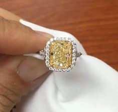 5 CT Yellow Radiant Cut Moissanite Diamond Side two Tone Round Cut Diamond In Band 10K 14K 18K Solid White Gold Engagement Ring Wedding Ring R I N G M E T A L ✥ Metal : 10K 14K 18K Solid White Yellow and Rose Gold, 925 Sterling Silver ✥ Metal Clarity : 100% Pure ✥ Stamp/Hallmark : Yes. Will be Indicated Inside The Ring M A I N S T O N E S ✥ Type : Moissanite  Diamond ✥ Center Diamond Shape : Radiant Brilliant Cut Diamond ✥ Center Diamond Weight : 4 CT ✥ Center Diamond Color : Yellow ✥ Side Diamond Shape : Round Cut Diamond ✥ Side Diamond Weight : 1.2 CT ✥ Clarity : VVS1 ✥ Diamond Cut : Excellence R I N G S I Z E S ✥ All Ring Size are Available ✥ Free Sizing ✥ If You Have any Questions With Regards to Sizing Please Contact as ✥ Please Send me a Message If You Need a Size not Listed S H I P Yellow Platinum Diamond Wedding Ring, Yellow Diamond Wedding Ring With Halo Setting, Gia Certified Yellow Diamond Wedding Ring, Yellow Gia Certified Diamond Ring For Wedding, Yellow Gia Certified Diamond Wedding Ring, Radiant Cut Yellow Jewelry For Wedding, Yellow Radiant Cut Jewelry For Wedding, Gia Certified Cubic Zirconia Halo Wedding Ring, Yellow Diamond Ring For Wedding