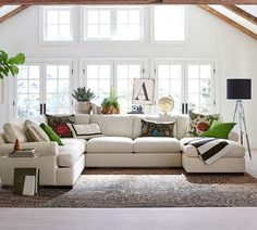 a living room filled with furniture and lots of windows