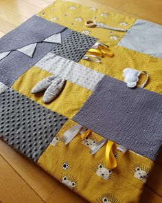 a yellow and gray patchwork quilt with scissors on it