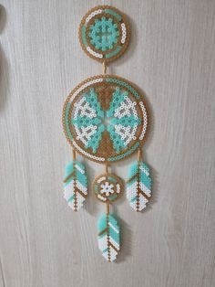 a beaded dream catcher hanging on a wall