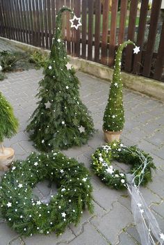 small christmas trees are arranged on the ground