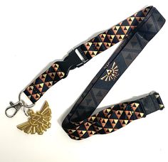 PRICES MAY VARY. Officialy Licensed Detatchable Clasp makes this lanyard Perfect for keychain, cell phone, camera, MP3, ID Badge etc.... Double Sided Print - Zelda Hyrule Emblem with Black Background / Tri-Force EmblemPattern with Black Background Gold Metal Hyrule Charm. Measures 1.75" x 1.25" The Legend of Zelda Hyrule Crest Double Sided Lanyard with metal clasp to be used as a keychain, ID Badge Holder, and Charm. Show off your Zelda gamer pride with this high quality lanyard - whether your a Zelda Keychain, Background Gold, Nintendo Game, Phone Camera, Id Badge Holders, The Legend Of Zelda, Badge Holder, Id Badge, Badge Holders