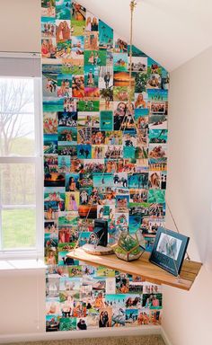 a wall with many pictures on it and a shelf in front of the window,