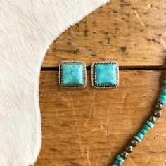 Kingman turquoise sterling silver stud earrings.
​Turquoise center stones with rope trim detail.
​Simple, yet classic. 
​The perfect touch of turquoise to your western fit.