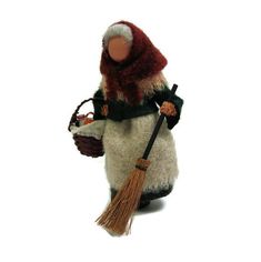 a stuffed snowman holding a basket and broom