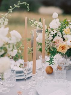 an image of a table setting with flowers and candles