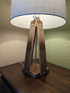 a wooden table with a lamp on it