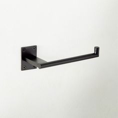 an image of a black towel rack on the wall with white walls in the background