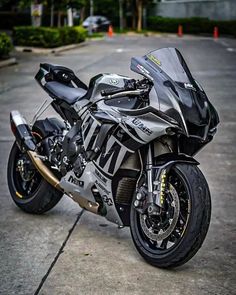 a black and silver motorcycle parked in a parking lot