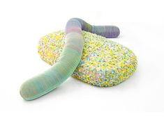 a colorful sock laying on top of a pillow with sprinkles around it