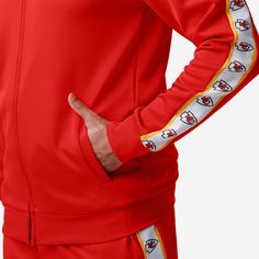 A jacket that you'll be jacked up to wear. Bundle up for your jog around the block with this Kansas City Chiefs Stripe Logo Track Jacket. Features All-over team-colored design so you can rep the team in style Embroidered team logo display on left chest, in case there were any doubts where your allegiances lie Stripe accents on sleeves with repeat team logo displays for a little extra team spirit Zip-up structure so you can zip up and party down Long sleeves so you can stay warm, even on the chil Team-colored Outerwear With Team Name For Game Day, Team-colored Outerwear With Team Name For Sports Events, Team-colored Outerwear With Team Name For Sports Season, Team-colored Outerwear For Game Day With Team Spirit, Team-colored Collegiate Outerwear For Sports Events, Team-colored Outerwear For Game Day, Team-colored Long Sleeve Track Jacket For Game Day, Sporty Game Day Outerwear With Team Name, Sports Season Fan Gear Track Jacket