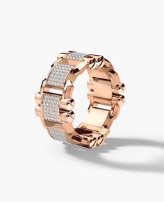 a rose gold ring with two rows of diamonds on the inside and outside, set against a white background