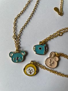 Introducing the BT21 Gold Plated Chain and Character Pendant, the perfect accessory for any BTS fan! This stunning gold chain features adorable BT21 characters including Koya (RM), Chimmy (Jimin), Cooky (Jungkook), and Mang (JHope). The chain measures approximately 45cm and is perfect for adding a touch of Kpop style to any outfit. Please note that this is an unofficial/fan made product and will be sent in a beautiful purple velvet gift bag. Sourced from a company in China, this one-of-a-kind pi Cute Gold Chain Jewelry, Playful Gold Charm Necklace, Cute Gold Necklace With Adjustable Chain, Playful Gold Jewelry With Adjustable Chain, Playful Gold Charm Necklace As Gift, Playful Gold Necklaces With Charms, Bt21 Characters, Kpop Style, Purple Velvet