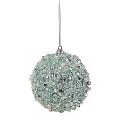 a glass ball ornament hanging from a string on a white background with beads