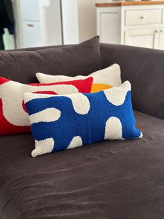 three pillows on a couch in a living room