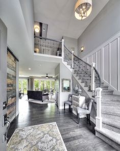 a living room filled with furniture and a stair case