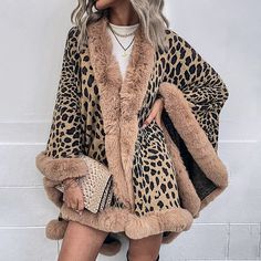 Elevate your autumn and winter fashion with our Fur Collar Leopard Print Cape Cardigan Shawl Sweater for Women. This unique and stylish piece is designed to keep you both cozy and fashionable during the colder months.Wrap yourself in the warmth and sophistication of this versatile cape cardigan. The leopard print adds a touch of wild elegance to your ensemble, while the fur collar enhances the overall charm and comfort. Whether you're heading out for a special event or simply want to make a statement, this cardigan has you covered.Key Features:Chic leopard print design for a bold and fashionable lookLuxurious fur collar for added style and warmthSoft and cozy fabric for ultimate comfortIdeal for autumn and winter seasonsVersatile and suitable for various occasionsOur Fur Collar Leopard Pri Mantel Cape, Print Outerwear, Asymmetrical Cardigan, Shawl Sweater, Poncho Cardigan, Leopard Sweater, Knitted Cape, Capes For Women, Mini Robes