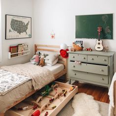 a child's bedroom with toy cars and toys in the drawer on the bed