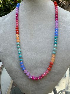 Embrace the vibrant energy of the rainbow with the Rainbow Radiance Chakra Necklace. This eye-catching piece features a gradient of colorful beads, each corresponding to one of the seven chakras. Designed to balance your energy centers, this necklace is not only a beautiful accessory but also a powerful tool for spiritual alignment and healing. Wear it to infuse your day with positivity and harmony. Materials: Mixed gemstones (Amethyst, Carnelian, Aventurine, and more) Length: 20 inches Closure: Toggle clasp Adjustable Rainbow Crystal Necklace With Faceted Beads, Adjustable Multicolor Crystal Necklace With 8mm Beads, Rainbow Faceted Beads Necklace For Gift, Rainbow Gemstone Beaded Necklaces For Gift, Rainbow Gemstone Beaded Necklaces As A Gift, Rainbow Crystal Necklaces With Round Beads Gift, Rainbow Beaded Necklace With Gemstone Beads For Gift, Rainbow Beaded Necklaces With Gemstone Beads As Gift, Adjustable Rainbow Beaded Necklace