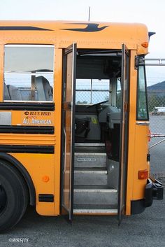 a yellow school bus with its door open and steps up to the front seat area