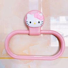 a hello kitty toothbrush holder hanging on the wall